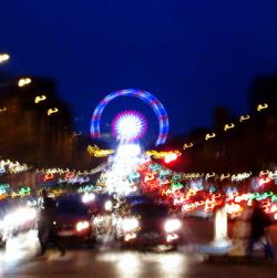 Illuminated ferris wheel at night