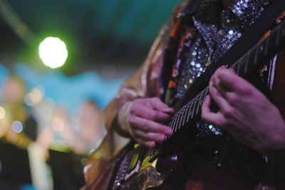 Close-up of hands playing guitar