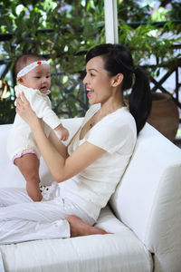 Close-up of mother playing with daughter at home