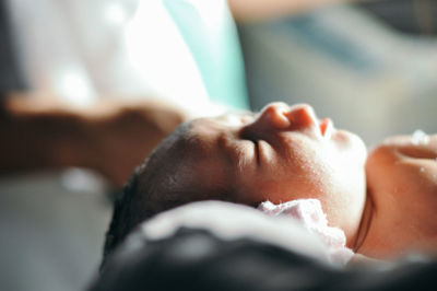 Close-up of baby lying on hand