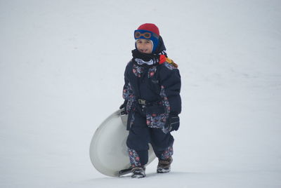 Portrait of woman standing in snow