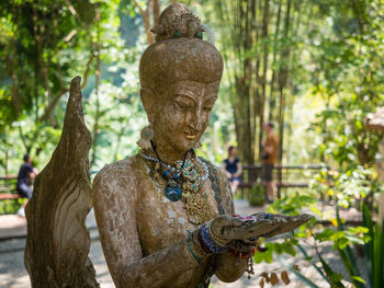 Statue of buddha against trees