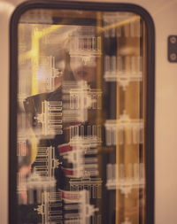 Portrait of young man seen through glass window