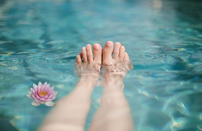 Low section of woman swimming in pool