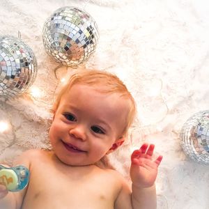 High angle view of shirtless cute baby boy by decoration on bed at home