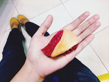 Cropped image of hand holding food