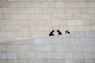 High angle view of people walking on tiled floor