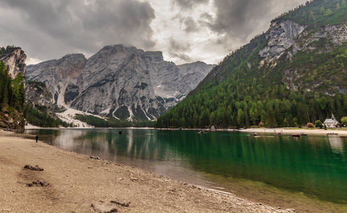 Scenic view of lake by mountains against sky