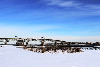 Low angle view of bridge against blue sky