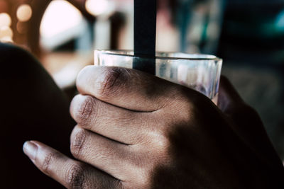 Close-up of hand holding cigarette