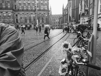 People on railroad tracks in city