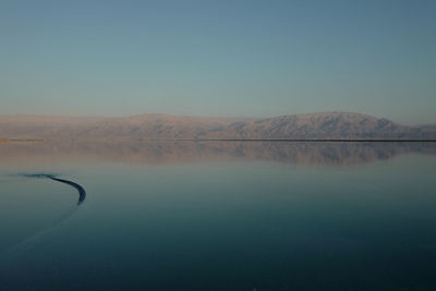 Scenic view of lake against clear blue sky