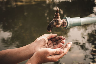 Close-up of hand holding water