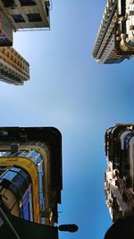 Low angle view of buildings against blue sky
