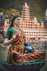 Statue of buddha against building