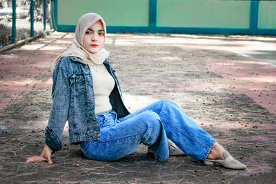 Portrait of young woman sitting outdoors