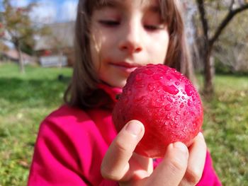 Cropped hand holding apple