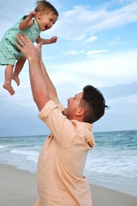 Father playing with son at beach