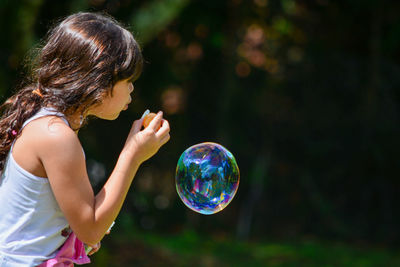 Full length of woman bubbles against blurred background