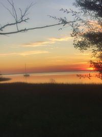 Scenic view of lake against orange sky