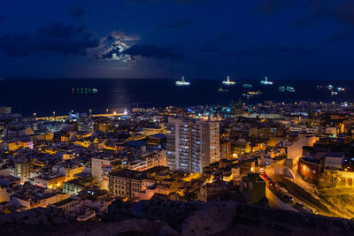 High angle view of illuminated buildings in city at night