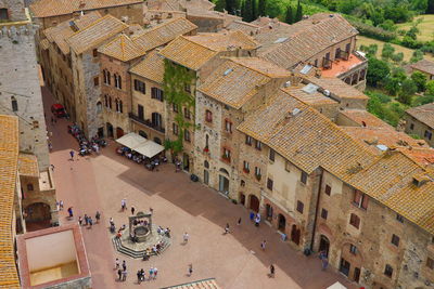 High angle view of people on street amidst buildings in town