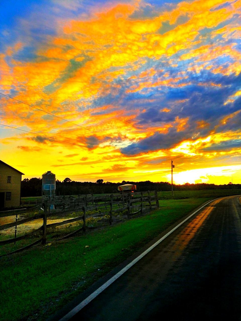 SCENIC VIEW OF LANDSCAPE AGAINST ORANGE SKY