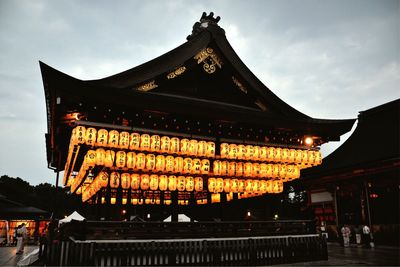Illuminated building against sky at dusk