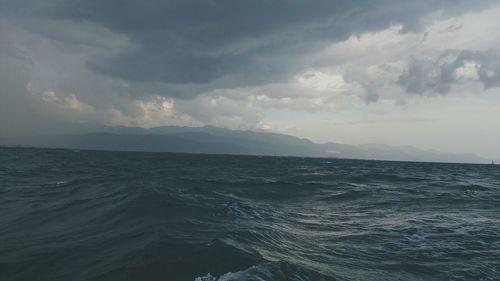 View of calm sea against cloudy sky