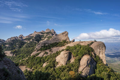 Rock formations on landscape against sky