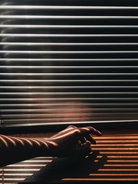 Close-up of hand on window sill