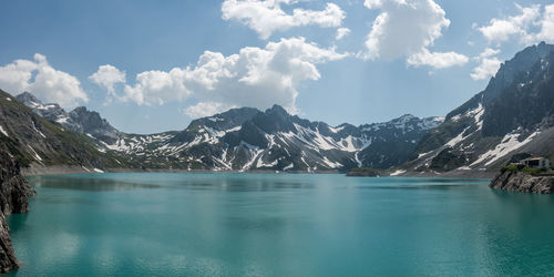 Scenic view of lake and mountains against sky