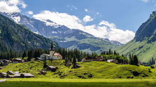 Scenic view of field and mountains against sky