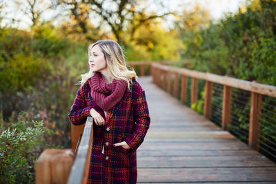 Young woman standing on footbridge