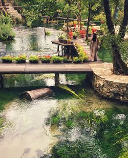 People on footbridge over water