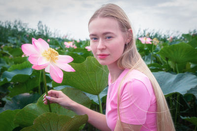 Portrait of young woman holding flower