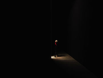 Woman walking on street at night