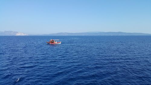 Side view of boat in calm blue sea
