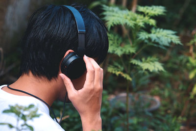 Rear view of woman photographing