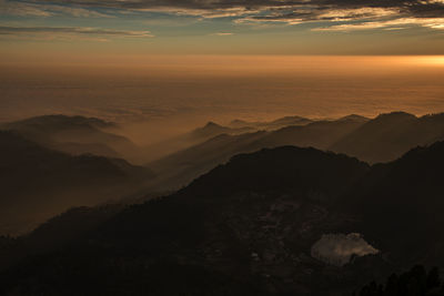 Scenic view of silhouette mountains against sky during sunset