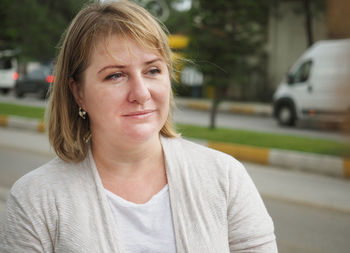 Close-up of mature woman looking away in city