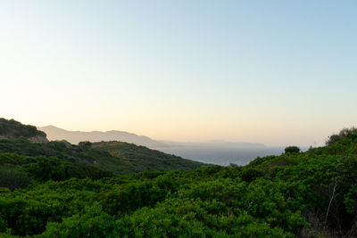 Scenic view of mountains against clear sky during sunset