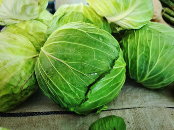 Close-up fresh wet green cabbage for sale with selective focus