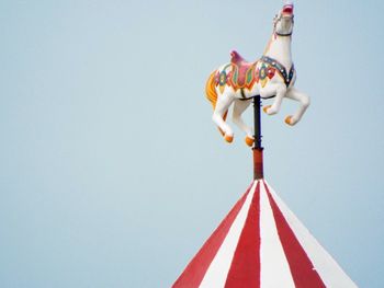 Low angle view of umbrella against clear blue sky