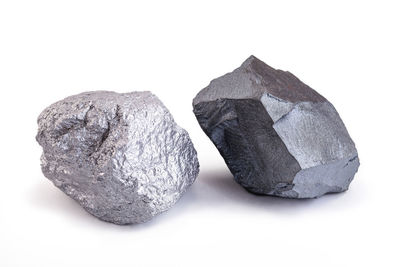 High angle view of bread on rock against white background