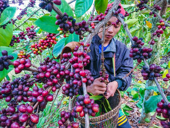 Full length of woman holding fruits