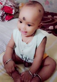 Portrait of a smiling girl sitting at home