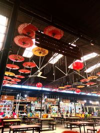 Low angle view of illuminated lanterns hanging on ceiling at night