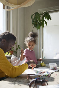 Mother and daughter drawing together