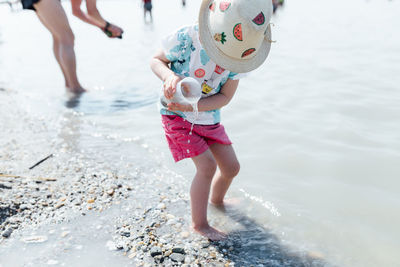 Low section of girl playing in water